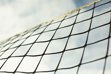 Sports net. Volleyball equipment. Grid against sky.