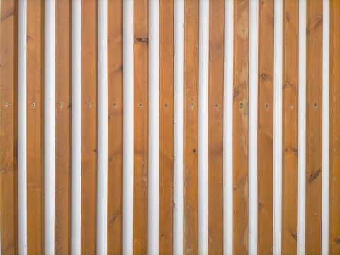Seamless texture of decorative wooden sticks placed vertically,with white background.