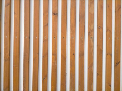 Seamless texture of decorative wooden sticks placed vertically,with white background.