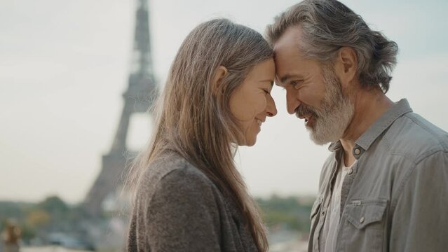 Happy senior couple in Paris. Senior woman and man spending time together at the eiffel tower. Concept about european tourism and landmarks	