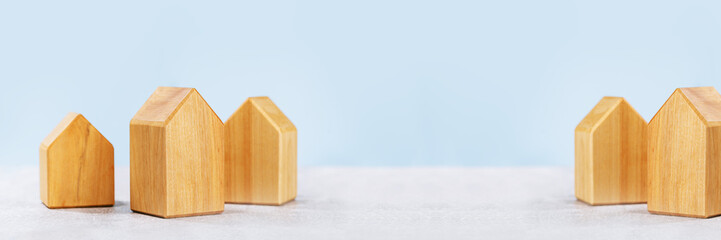 mortgage calculator or real estate business concept. Office desk with a white and wooden houses....