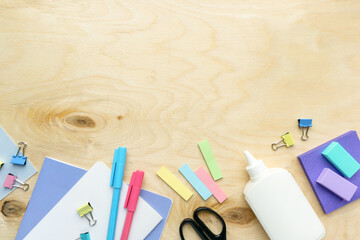 Flat lay of various stationery for school and office on wooden background, copyspace