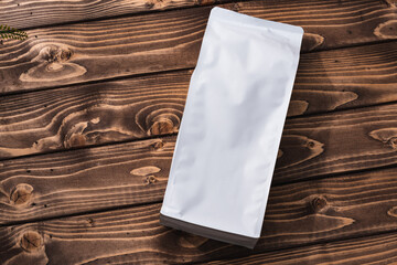 Blank coffee bag on wood table copy space