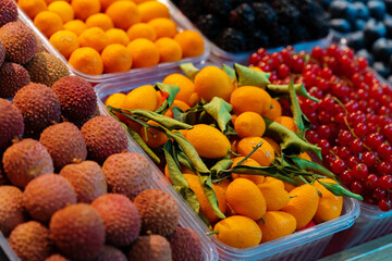 Colorful fruit berries are displayed in a market