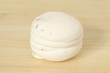Zephyr on a light background. Sweet dessert marshmallow with raspberry filling.
