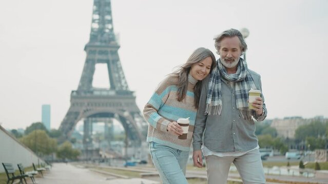 Happy senior couple in Paris. Senior woman and man spending time together at the eiffel tower. Concept about european tourism and landmarks	