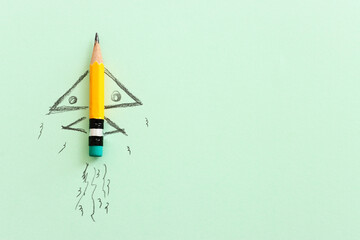 Pencil and rocket sketch over textured paper, concept of back to school, creativity and success