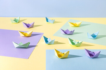 Small pastel boats made by folding colourful paper