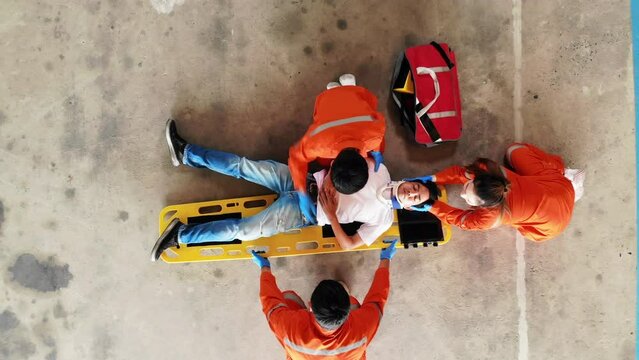 Top view of Asian patient man are lifted and moved by Emergency medical technician (EMT), Lifting and Moving Patients concept