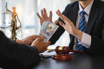 lawyer or judge is refusing bribes. In the client's courtroom at the lawyer's office In order to...