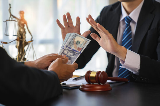 lawyer or judge is refusing bribes. In the client's courtroom at the lawyer's office In order to bribe to gain an advantage in the form of lawsuits, the concept of bribery and corruption