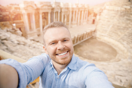 Tourist taking selfie photo background Amphitheater in Hierapolis ancient city Pamukkale Turkey