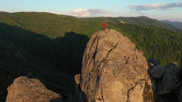 Traveler on Top of Mountain and Hands Raising in a Sunset Light.