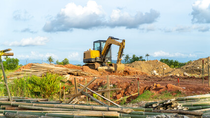 Excavator working in a field. Excavator parked at the construction project site. Excavator without...