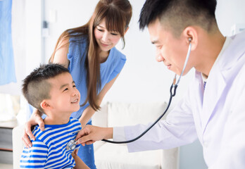  Male pediatrician hold stethoscope exam child boy patient visit doctor with mother