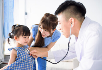  Male pediatrician hold stethoscope exam child girl patient visit doctor with mother