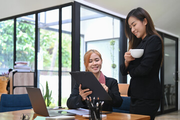 Two business colleagues discussing corporate business plan together at corporate office