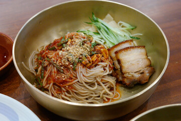 Buckwheat Noodles are served in a brass bowl.