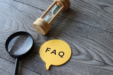 Hourglass, magnifying glass and speech bubble with text FAQ. Frequently asked question concept