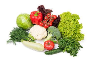 Variety of organic vegetables cabbages, zucchini and leafy greens isolated on white