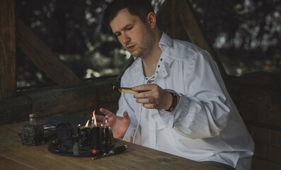 Man wizard with magical stuff. Halloween concept, masquerade or cosplay Medieval men's look