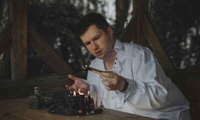 Man wizard with magical stuff. Halloween concept, masquerade or cosplay Medieval men's look
