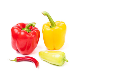Variety of red and yellow colored bell and chili peppers isolated on white, copy space