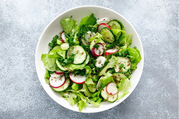 Salad with fresh green lettuce, radish and cucumber