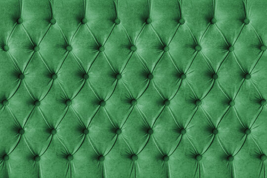 Green capitone checkered soft fabric textile decorative background with buttons. Classic retro Chesterfield style, luxurious upholstery buttoned texture for furniture, wall, headboard, sofa, couch