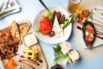 Greek dishes served with drinks on the restaurant table