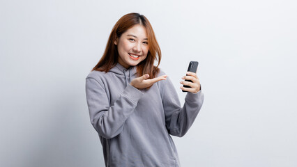 Fototapeta premium Beautiful Asian woman gesturing for advertisement editing on isolated background, portrait concept used for advertisement and signage, isolated over white background, copy space.