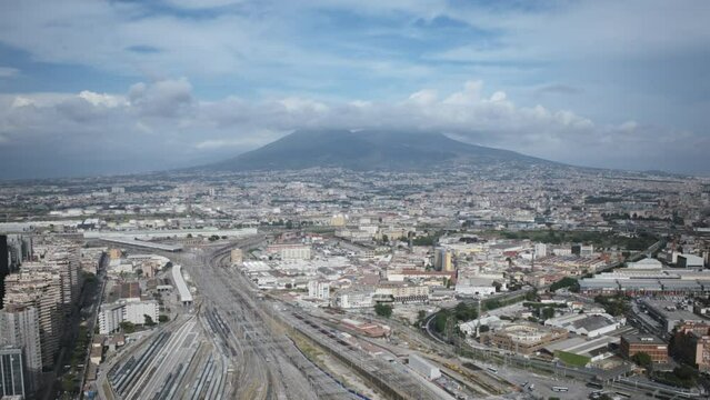 Aerial hyperlapse of Napoli Centrale train station in Naples, Italy with Mount Vesuvius in the background.