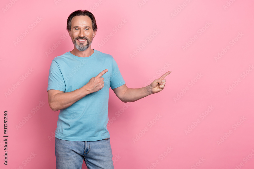 Poster Portrait of cheerful positive person direct fingers empty space ad blank isolated on pink color background