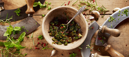 Grinded herbs near mezzaluna knives