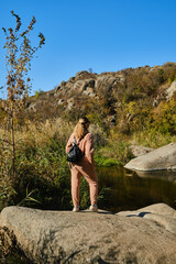 Hiker young woman with backpack on trekking trail
