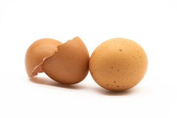 single egg and broken egg skin over on white background