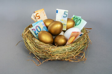 golden eggs with euro banknotes on gold table, concept of enrichment and wealth
