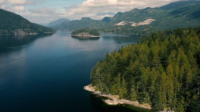 Men Catching Crabs In The Bay At Sechelt Inlet Surrounded With Mountains And Forest At Sunshine Coast In Egmont, Canada. - aerial forward