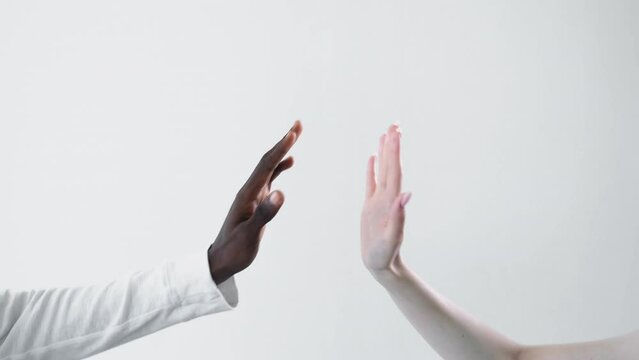 Multiethnic friendship. Global unity. Boomerang animation. Diversity relationship. African man Caucasian woman high five hand gesture gif loop isolated on white free space.