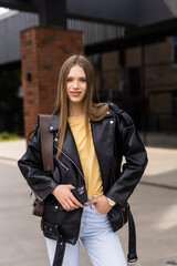 Happy young beautiful woman walking on the street.