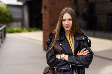 Happy young beautiful woman walking on the street.