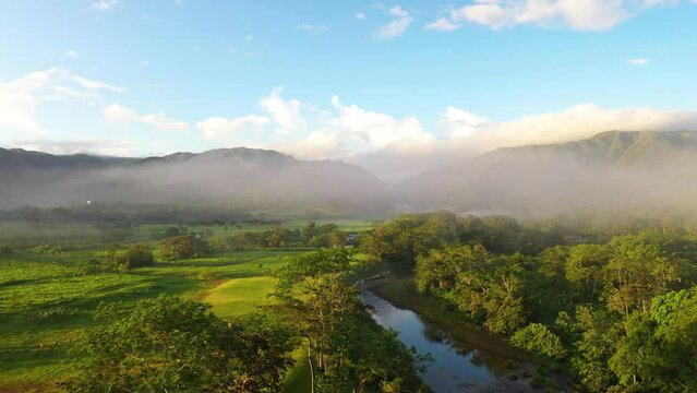 Jungle Valley Sunrise Aerial Shot Through Fog Mountain Reveal