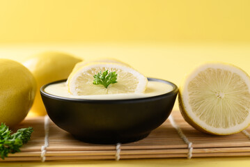 Lemon yogurt in bowl on yellow, Healthy eating and beauty skincare
