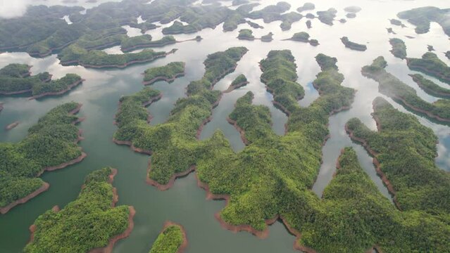 Ta Dung lake seen from above in the morning with small islands of paradise with beautiful abstract shapes. This is the reservoir for increase in Dac Nong, Vietnam.