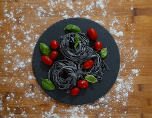squid ink tagliatelle with cherry tomatoes and basil
