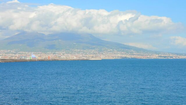 Shot of Naples skyline, port and Vesuvius volcano view in Naples, Italy on a sunny day.