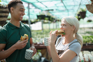 Happy garden shop owners enjoying lunch break