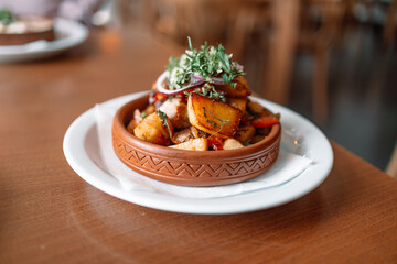 Georgian national dish ojahuri with meat on wooden background. 