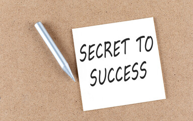 SECRET TO SUCCESS text on a sticky note on cork board with pencil ,