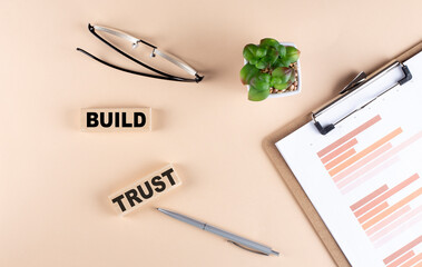BUILD TRUST text on a easel with wooden figure, meeting concept